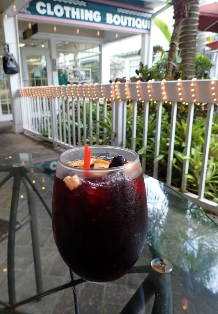 Enjoying a glass of sangria at an outdoor table at Chowder Heads restaurant in Jupiter, Florida
