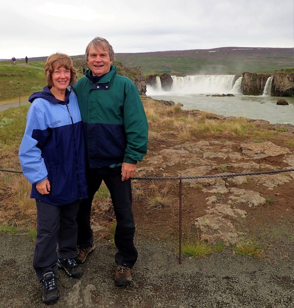 Linda and David, owners of On To New Adventures blog, in front of Iceland's Godafoss Falls