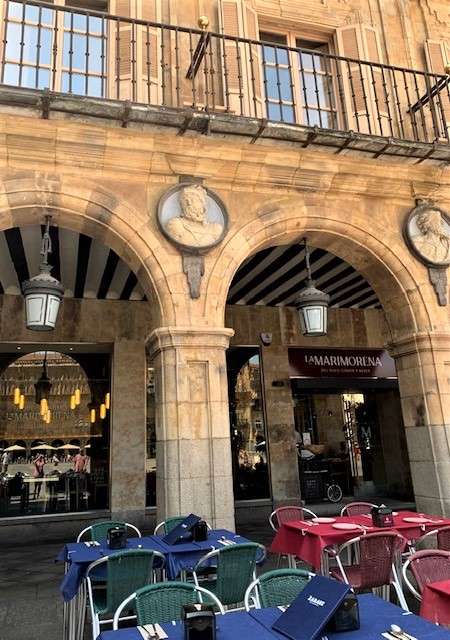 Arches along Salamanca's Plaza Major lead to an arcade filled with shops and restaurants