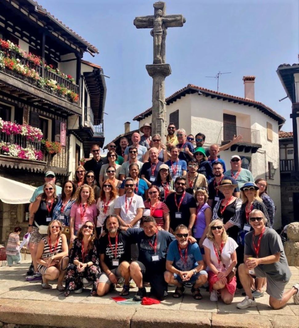 Pueblo Inglés participants in front of the stone cross in La Alberca, Spain