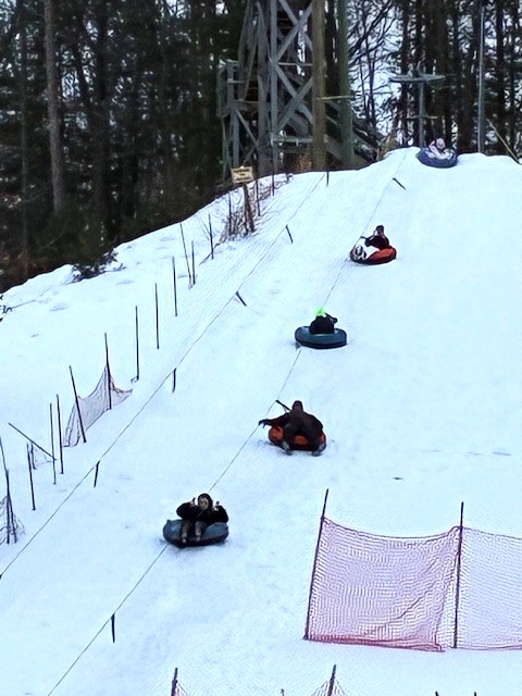 Riding up the snow tube lift at Mount Holiday in Traverse city