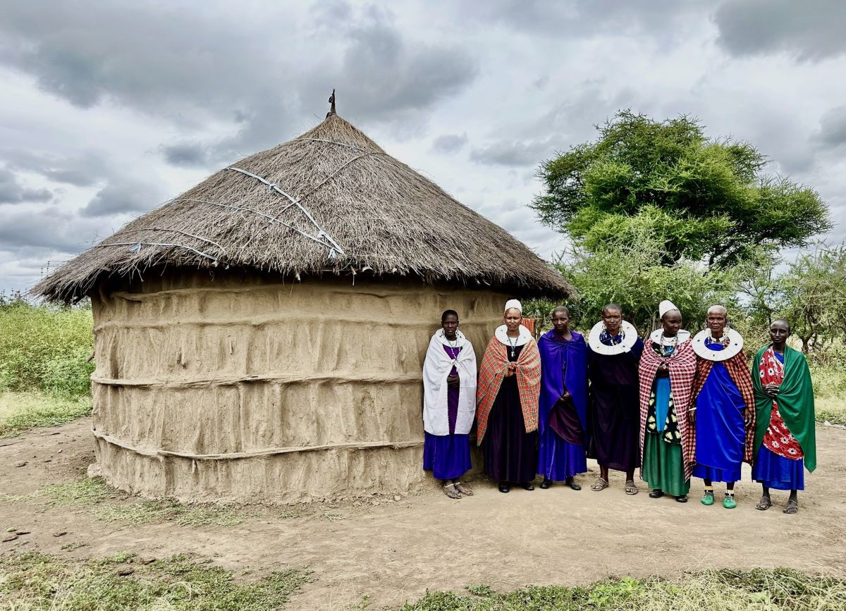 Maasai women outside a tradtional mud hut