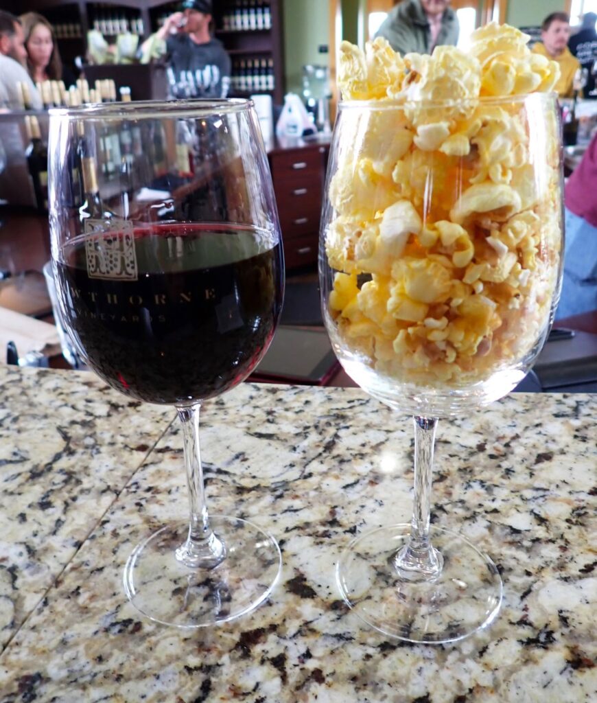 Enjoying a glass of Merlot/Cab Franc blend and buttery popcorn at Hawthorne Vineyards on Old Mission Peninsula