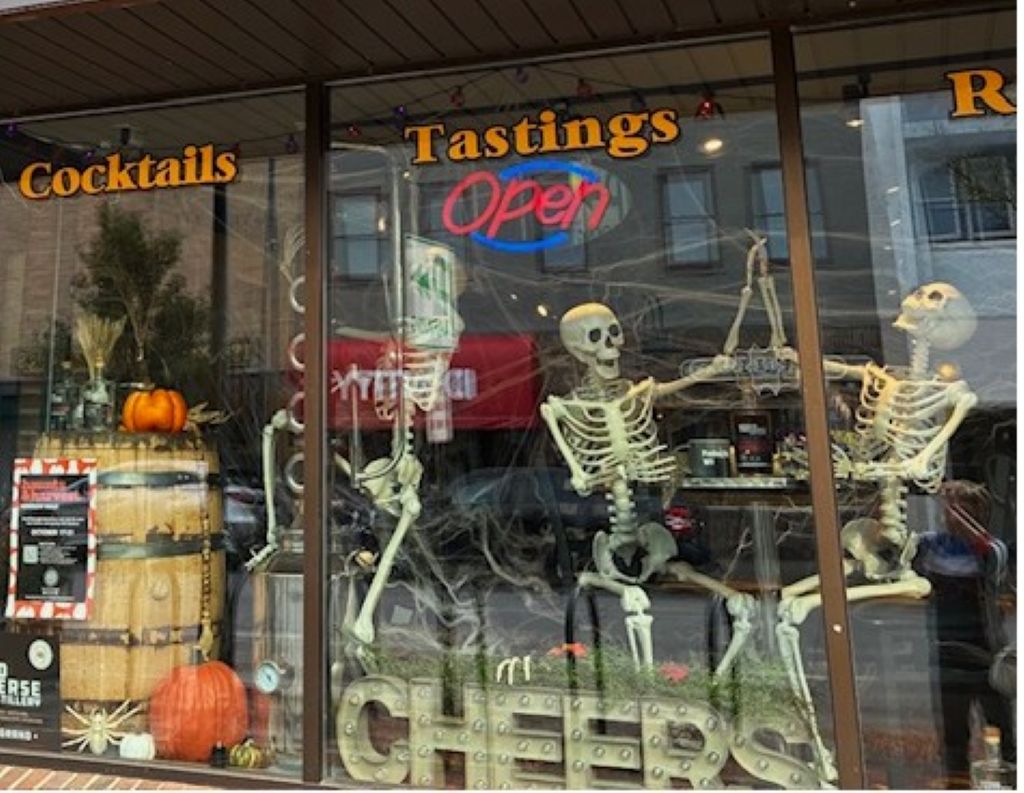Skeletons celebrating in the window display at Grand Traverse Distillery.
