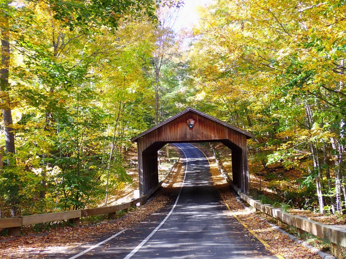 The covered bridge at the start of The Pierce Stocking Scenic Drive in fall.