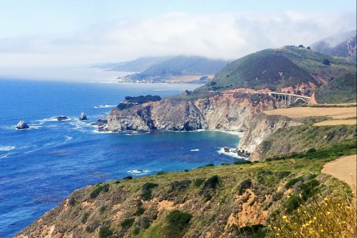 Emerald green cliffs that just melt into the wild blue Pacific Ocean await you in Big Sur, California when you visit in the spring. 