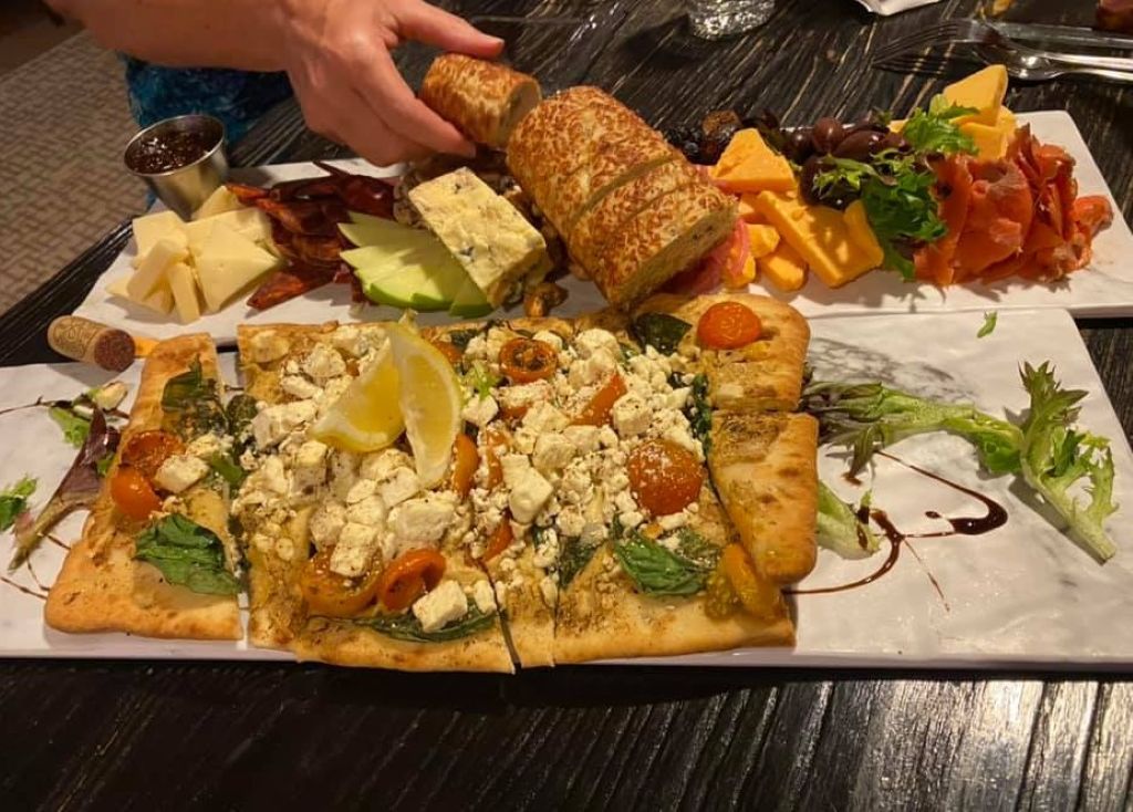 After a day of wine tasting, enjoy a charcuterie board at the Reflect Bistro, the restaurant located inside the Cambria Hotel Traverse City.