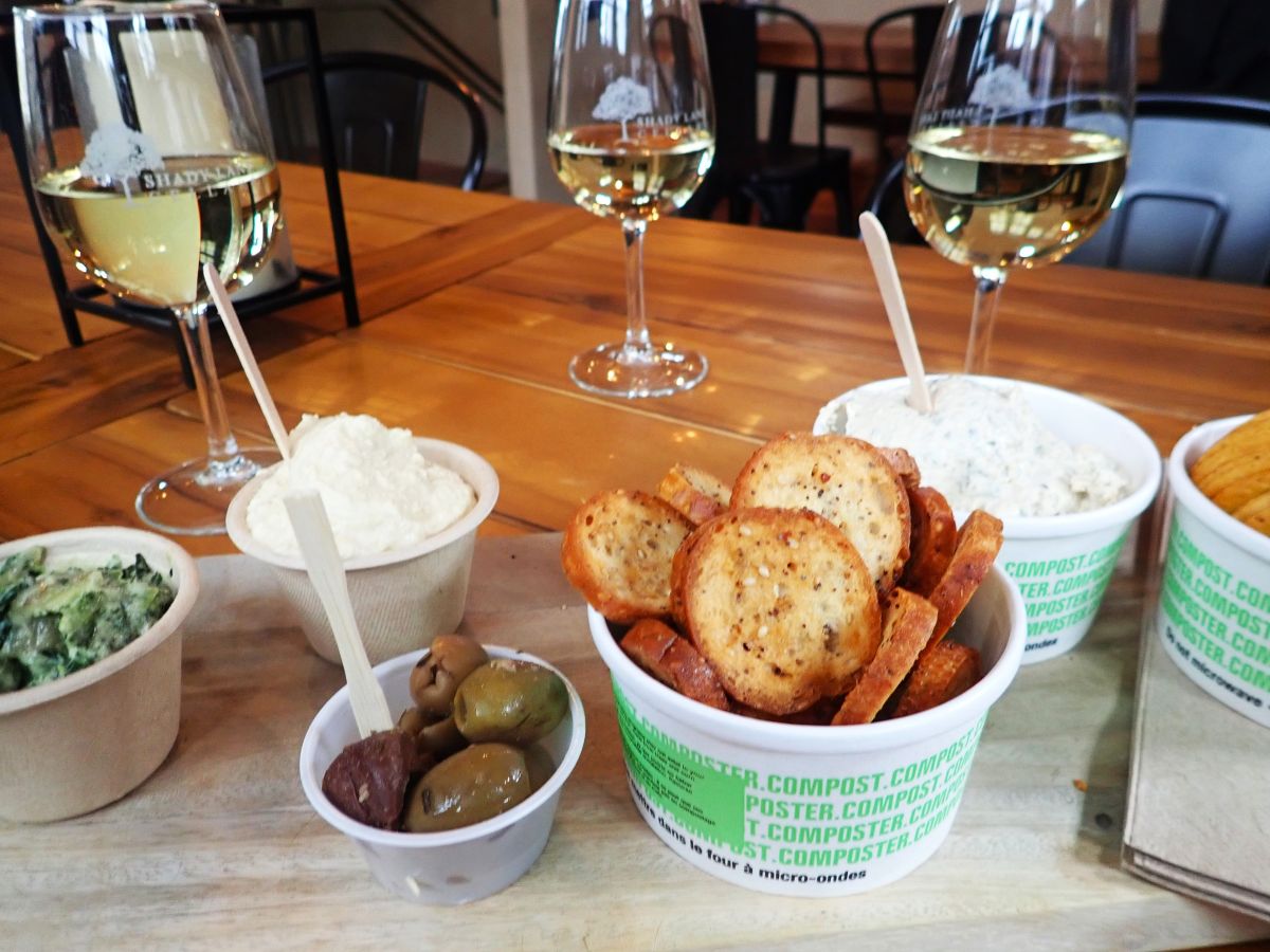 The Shade Lane Cellars offers charcuterie boards with artisanal cheeses, salami, and olives, along with snacks like hummus and smoked whitefish dip.