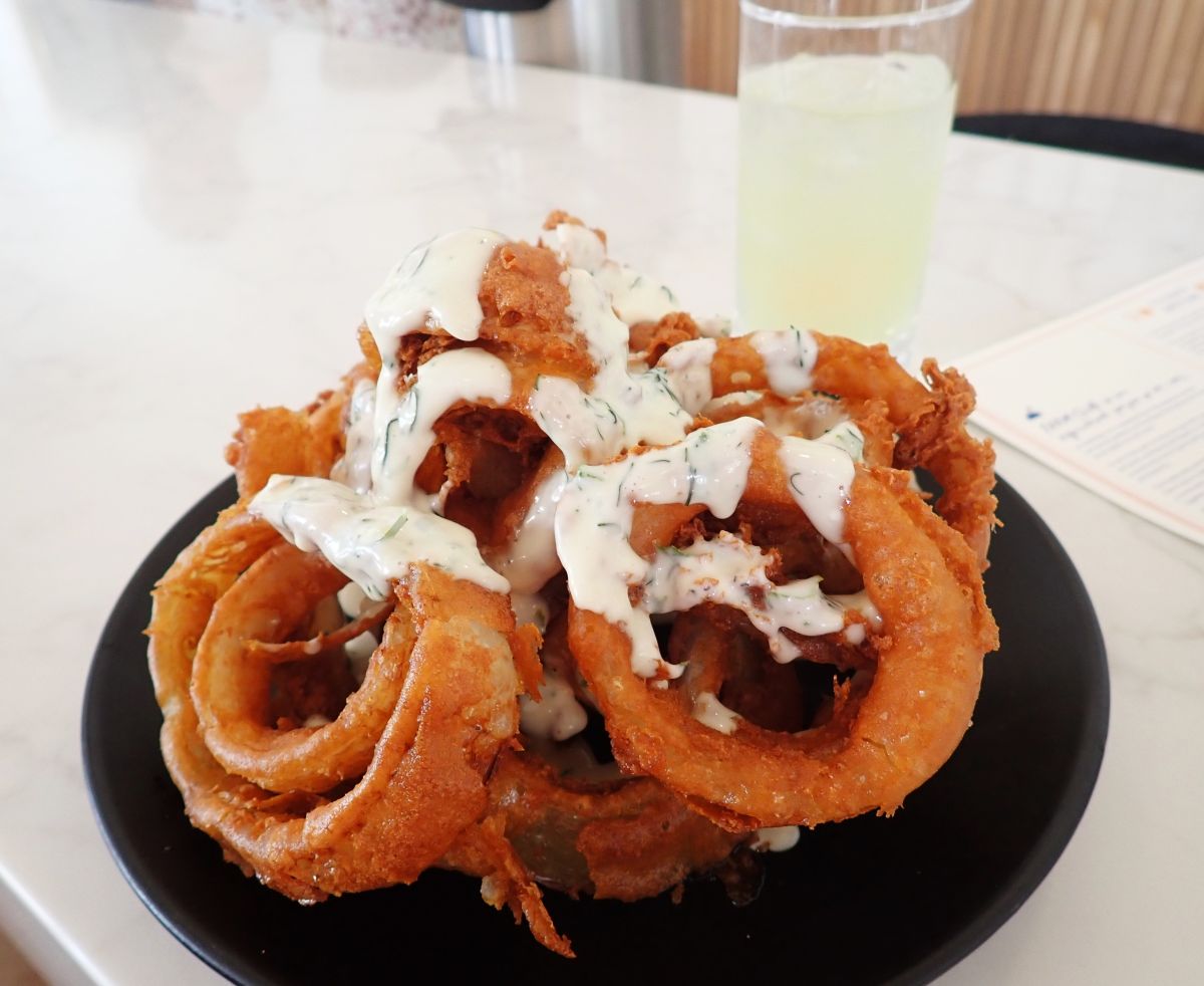 Farm Club's crowd pleasing onion rings  are cooked in a tempura beer batter with a garnish of creamy maple dressing. They are only available in the fall.