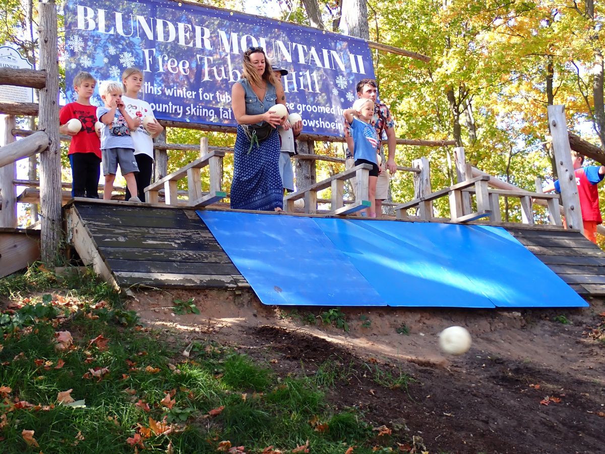 Kids will have a great time throwing pumpkins done the tubing hill at Pond Hill Farm during pumpkin bowling!