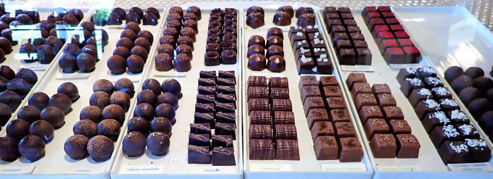 Grocer's Daughter Chocolate is pairing with Black Star Farms for Wine and Chocolate tastings this fall. This is a display of artisan chocolates from their shop in Empire.